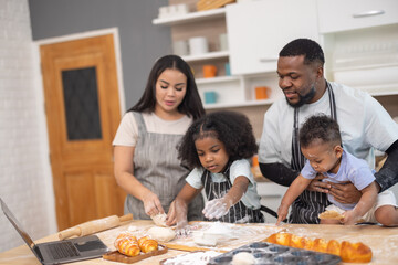 Family Bonding Over Baking Bread Using Online Recipe in Cozy Home Kitchen