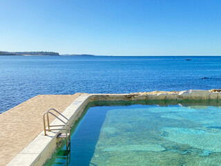 Public swimming pool near the ocean. Tidal pool. Rock Pool. Landscape, shore and view of the coast.