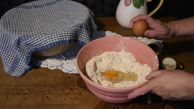 Preparing a cake vintage   bowl cracking an egg  into flour
