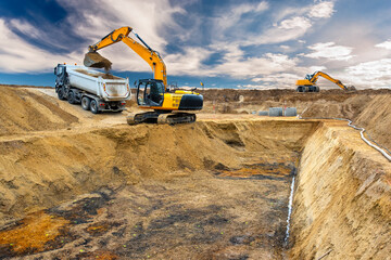  excavator is working and digging at construction site - 782179192