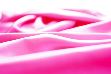 Light pink silk or satin wavy background beautiful and luxurious Space for design. Close-up....