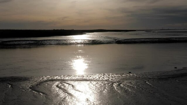 Dollard Estuary at Low Tide: Sunset Silhouette in Groningen, Netherlands