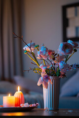 home interior with spring flowers and burning candles - 782191535
