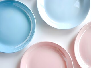 Top view , Pink, Blue, and light Blue pastel coloured plates on white background 