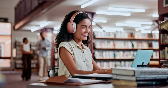 Headphones, dancing or woman in a library on laptop for knowledge, elearning or research in college. Online course, streaming music or happy university student studying information with scholarship