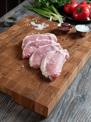 Large pieces of chopped pork meat on a beautiful wooden board.