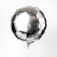 An isolated shiny silver round balloon captures the light with its reflective surface