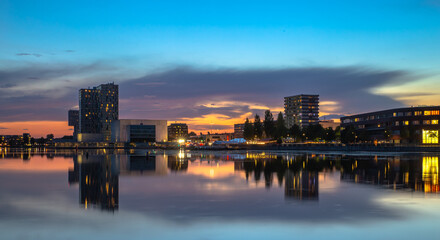 the sunset city skyline with reflection in the lake in Almere centre