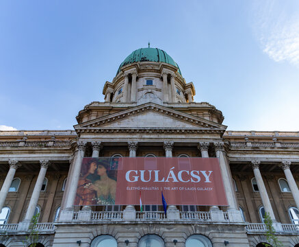 Budapest, Hungary - April 23, 2023: A picture of the Buda Castle and Hungarian National Gallery with the banner of the Lajos Gulacsy exhibition.