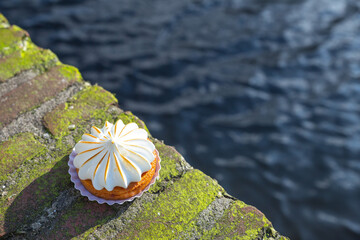 a lemon tart on the edge of water