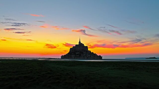 Aerial view of the highest tides in Europe. The Abbey of Mont-Saint-Michel in Normandy, France. Aerial view of French mountain at golden sunset.