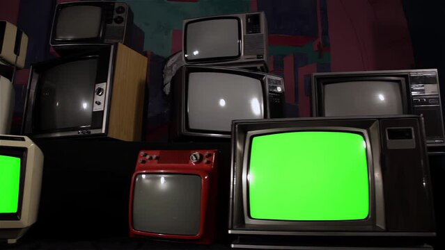 Old Analogue Televisions with Chroma Key Green Screen. Front Angle View. Dolly Shot. Zoom In. 4K Resolution.