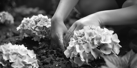 A person collecting flowers from the ground. Suitable for nature and gardening themes