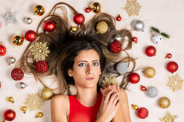 Young woman surrounded by Christmas's balls