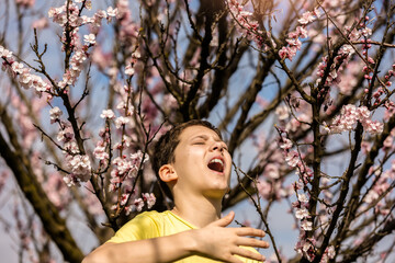 Child with pollen allergy. Boy sneezing because of seasonal allergy.