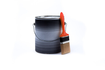 a closed gallon can of paint with a red paint brush laying against it isolated on white