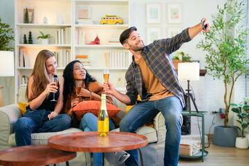 Friends capturing a joyful selfie moment with champagne, sharing laughter in a vibrant, homey...