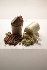 Chocolate and vanilla protein powder in scoops. Food supplement, nutrition 