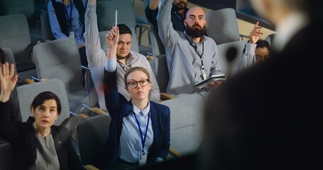 Diverse journalists, media workers raise hands and ask questions during press conference with...