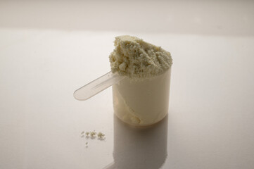 Vanilla protein powder in scoop. Food supplement, nutrition 