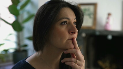 Pensive Woman in Her 30s Contemplating, Close-Up of Face in Deep Thought, Indoor Home Setting....