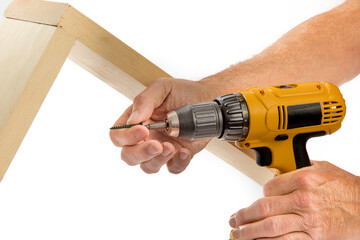 a man is using a battery powered electric drill with screwdriver attachment to drive a screw into a...