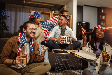 Multiracial group of friends watching sport at home with American flags.