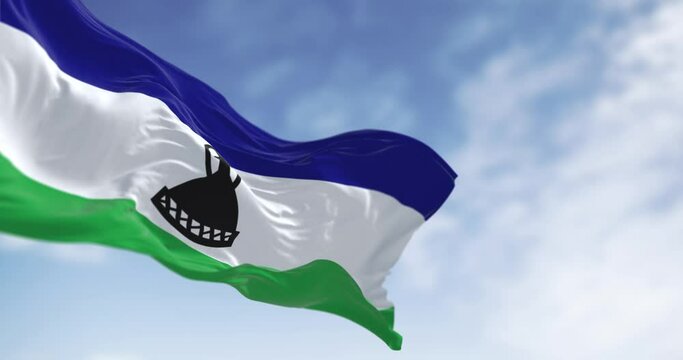 National flag of Lesotho waving in the wind on a clear day