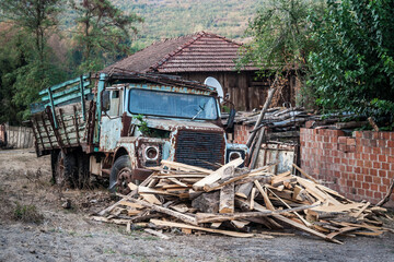 Fototapeta na wymiar Vintage Blue Truck Abandoned in a Rustic Village Setting