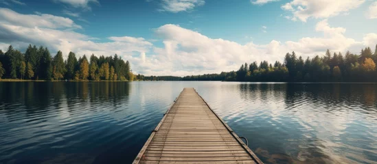 Poster Wooden pier stretching into lake © HN Works