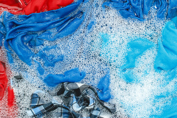 Washing clothes or laundry in soapy water