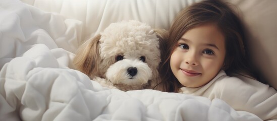 Girl cuddles toy dog under white blanket