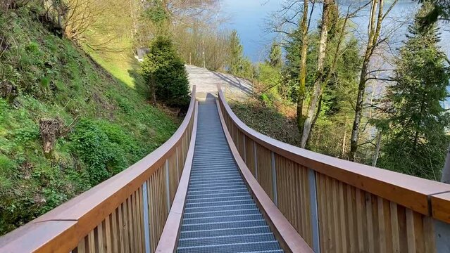 Crossing rope bridge staircase of hiking trail at Bürgenstock in the Swiss Alps on a sunny spring day. Movie shot April 11th, 2024, Bürgenstock, Canton Nidwalden, Switzerland.