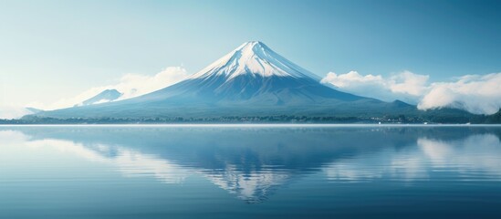 A serene lake in front of a towering mountain - obrazy, fototapety, plakaty