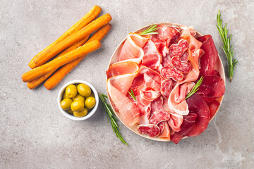 Charcuterie board. Antipasti appetizers of meat platter with salami, prosciutto crudo or jamon and...