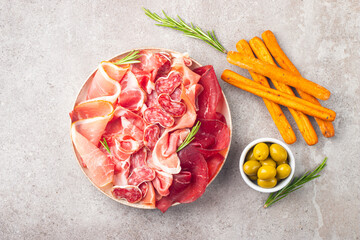 Charcuterie board. Antipasti appetizers of meat platter with salami, prosciutto crudo or jamon and olives. 