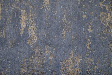 Gray and golden textured wall surface. Rough stylized texture. Abstract decorative background. Old effect background for wallpaper or graphic design.