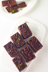 Delicious chocolate brownies with mint on white background. Sweet cake concept. 