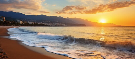 Naklejka premium Beautiful sunset over sandy beach waves