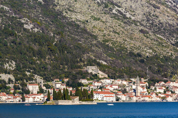 Historic Perast town in Montenegro with baroque architecture, panoram view against a mountain...