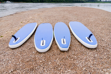 SUP boards on the river bank. Summer rest