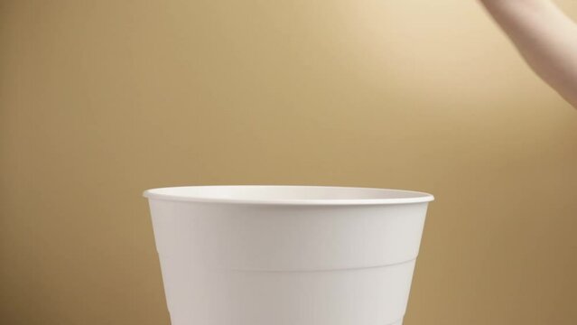 plastic recycling, separate waste collection, cosmetics recycling, environmental protection, waste sorting, a hand throws a jar of cream into a trash can