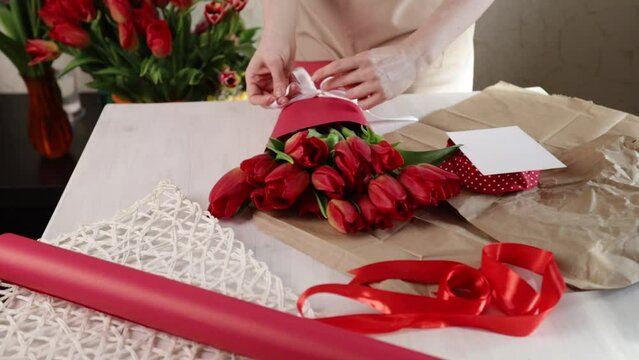 Florist in action, bouquet wrapping service, gift preparation, floral composition.