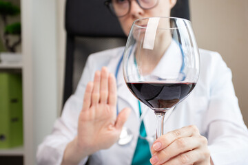stop alcohol,doctor shows hand rejection of a alcoholic drinks