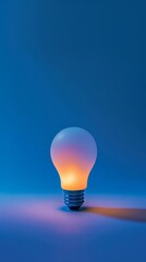 Glowing light bulb on blue background