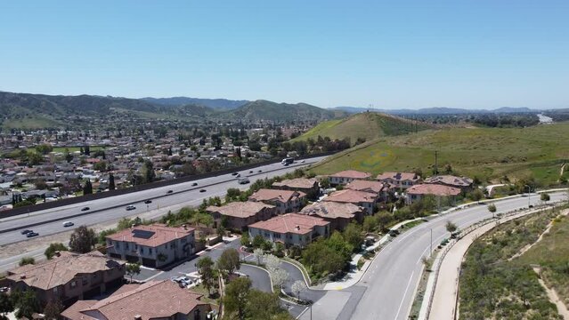 Drone rises over Simi Valley, Mountains, Highway, and Homes