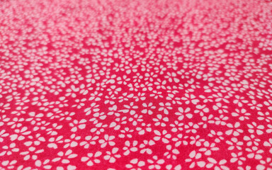 Floral fabric background in white and pink colors.