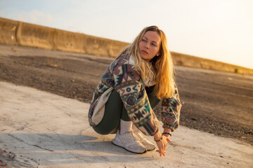 young sad poor woman seating alone at the street stressed and depressed