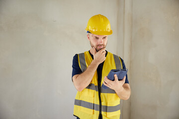 worker or architect working on tablet and home inspection at construction site