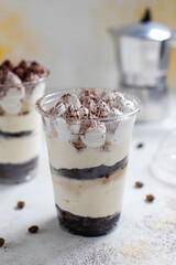 Traditional italian desert tiramisu in a jar.